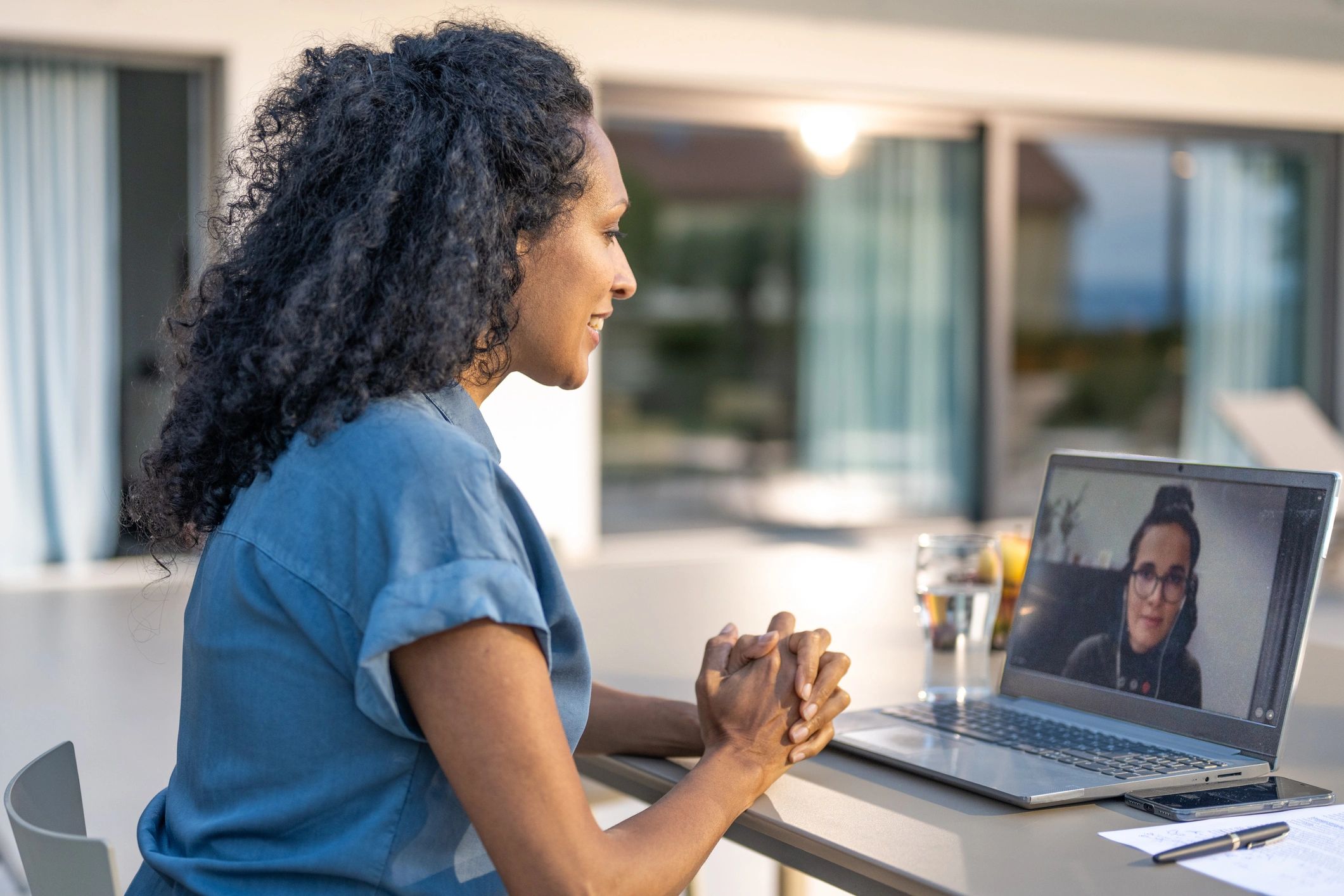 Person attending a video call on a laptop